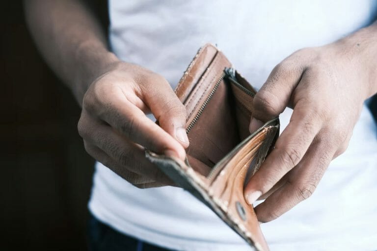 a person holding an empty wallet