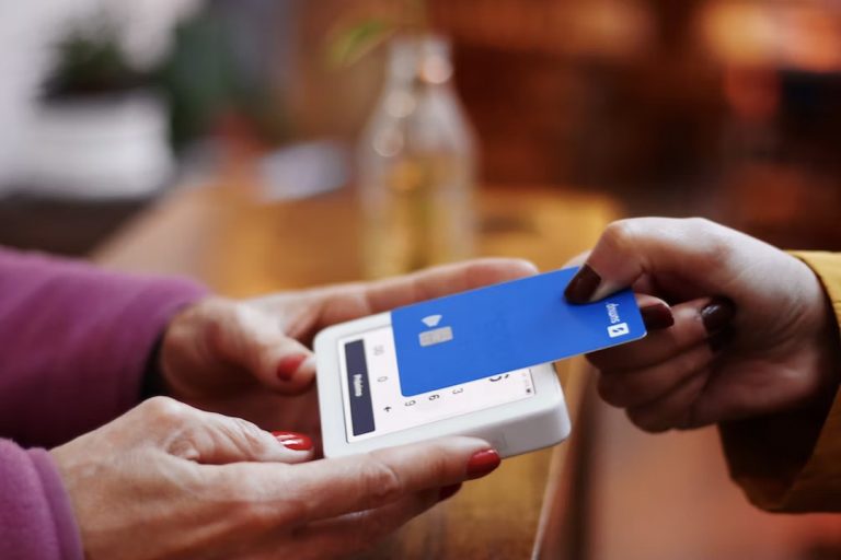 A person using a credit card for paying