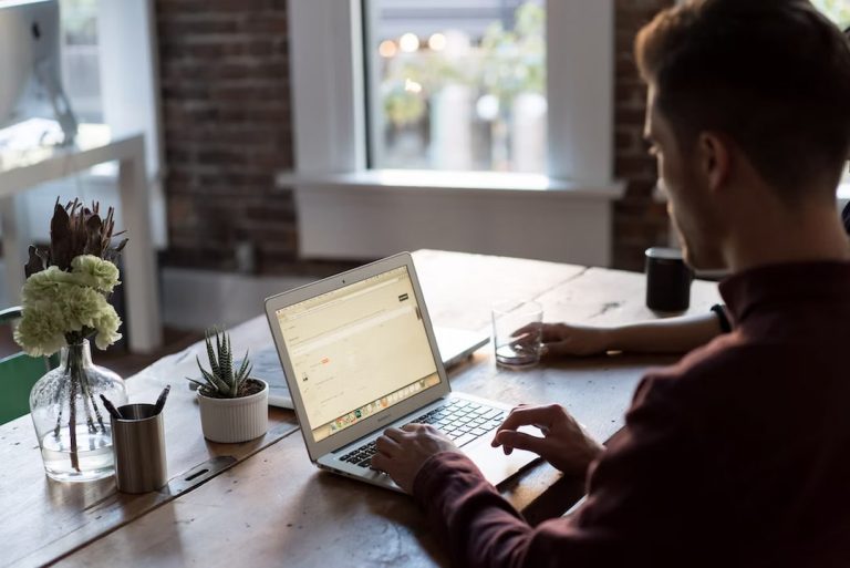 A man working on his laptop at the table